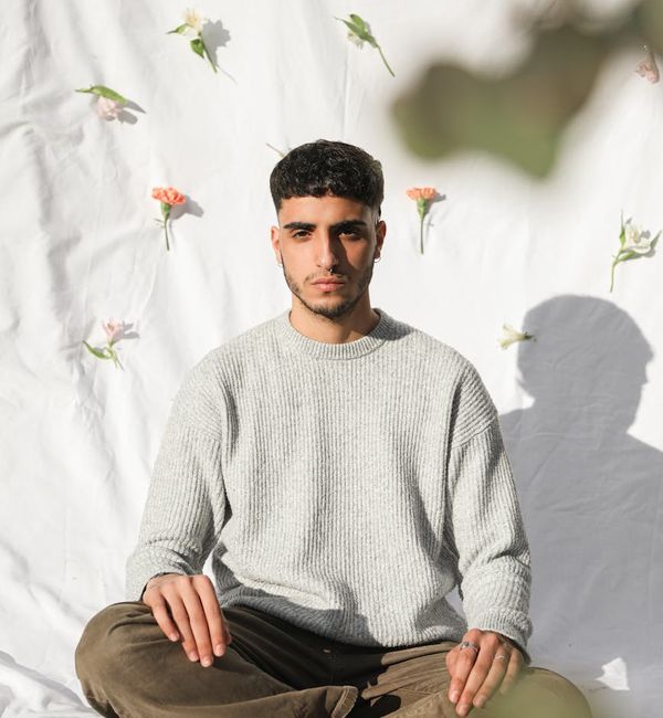 Silhouette of a person meditating peacefully against a serene background.